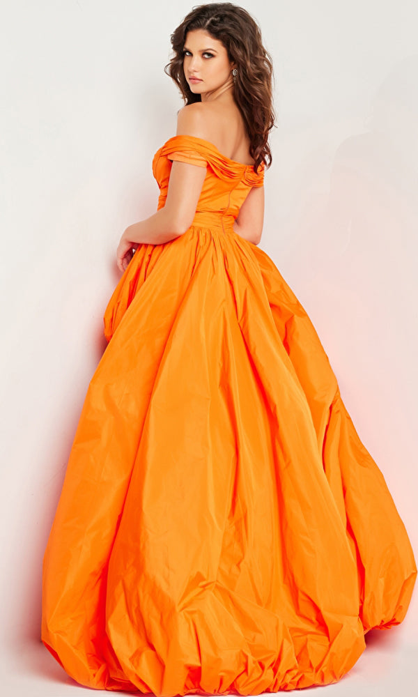 A woman in the Long High-Low Prom Dress 27804 by Jovani, featuring an off-the-shoulder taffeta design with a bright orange bubble skirt, stands against a plain white backdrop, looking over her shoulder at the camera.
